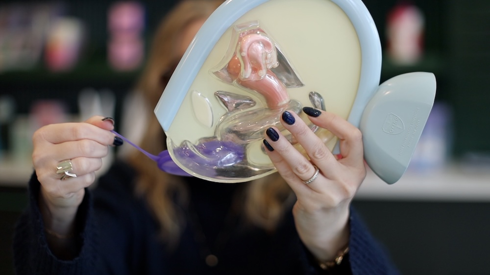 Woman shows how to remove the Fillow Disc from a pelvic model
